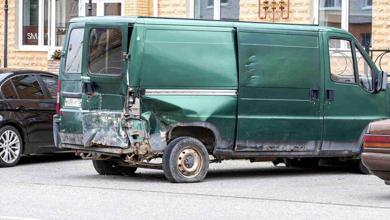 green dilevery truck accident in residential area